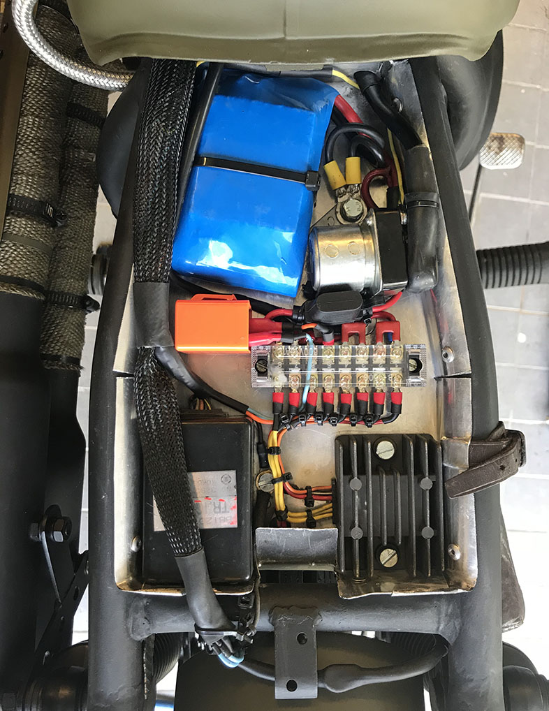 Elen och batteri kopplad under sätet på scrambler
